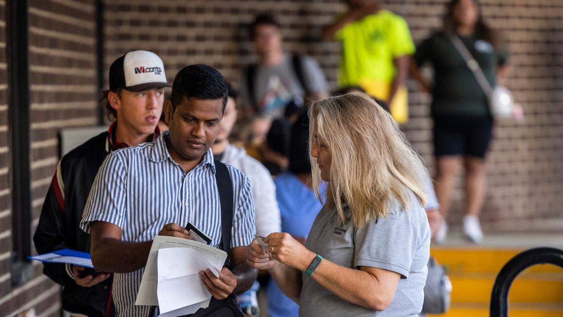 Drivers license examiner Sandra Barrett helps Gokul Annamalai make sure his documents are in order at the N.C. Division of Motor Vehicles’ West Raleigh DMV office on Sept. 2, 2022.