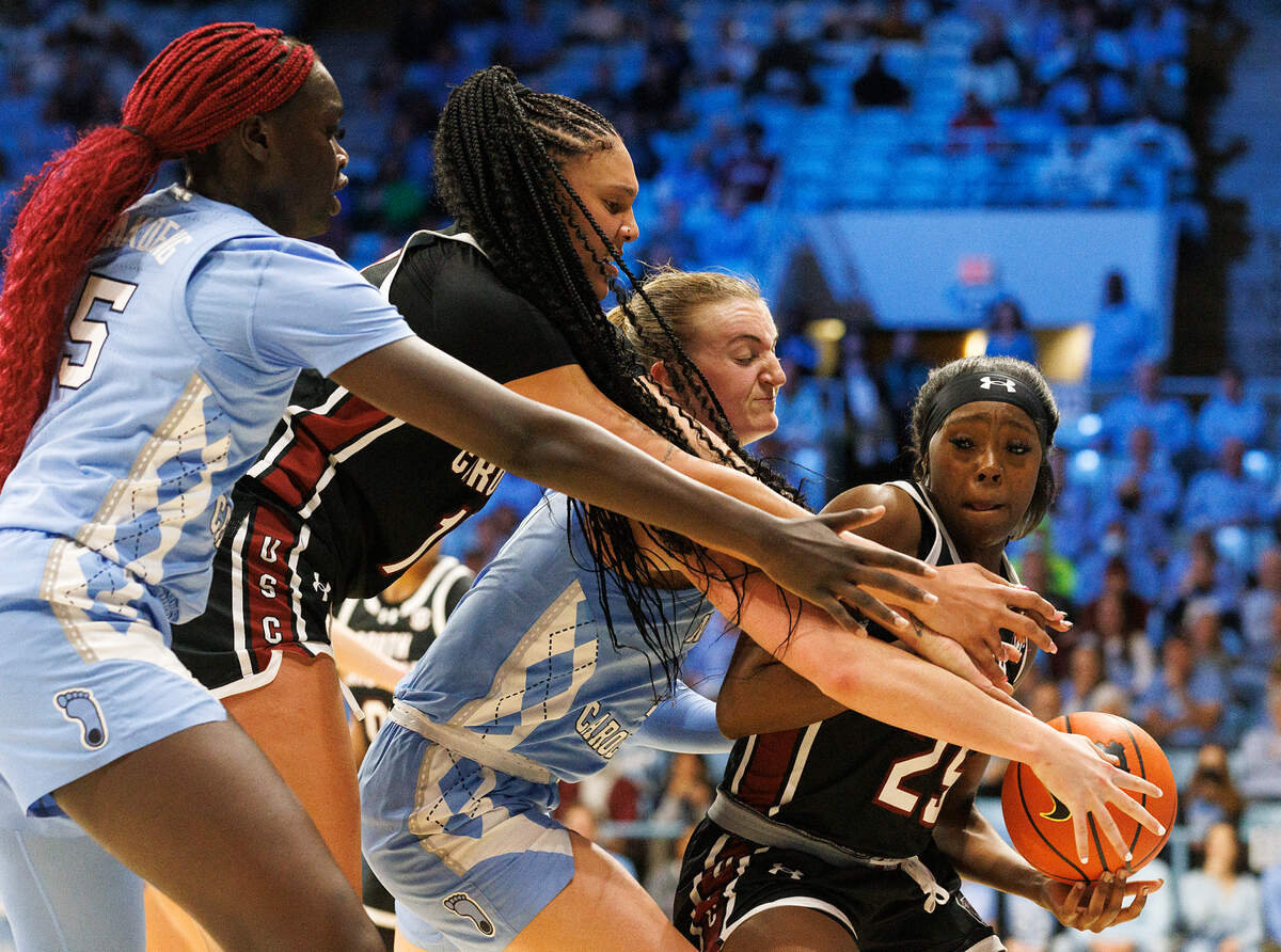 North Carolina’s Maria Gakdeng and Alyssa Ustby pressure South Carolina’s Raven Johnson, right, to force a turnover during the second half of the Tar Heels’ 65-58 loss on Thursday, Nov. 30, 2023, at Carmichael Arena in Chapel Hill, N.C.