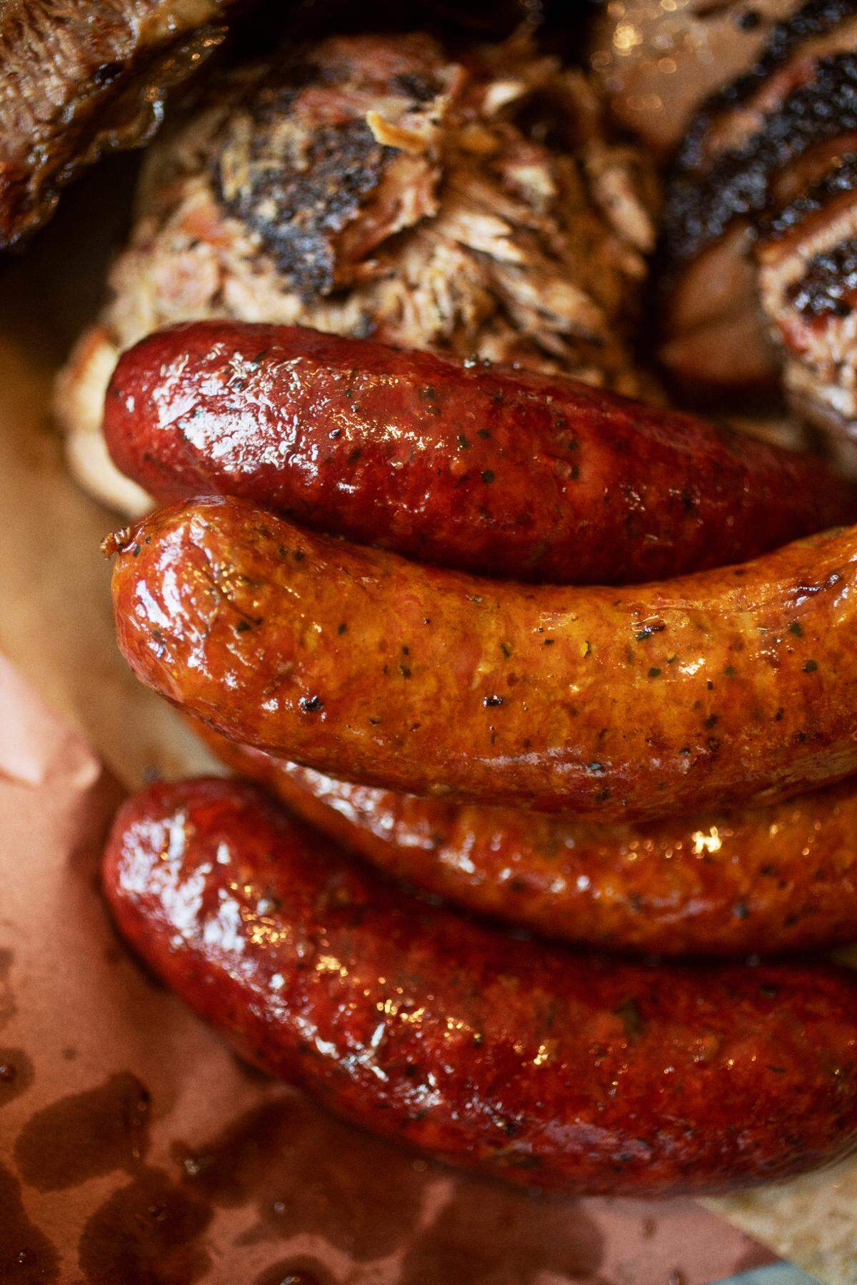 Jon G’s Barbecue serves Cheerwine and queso Texicano house-made sausage links.