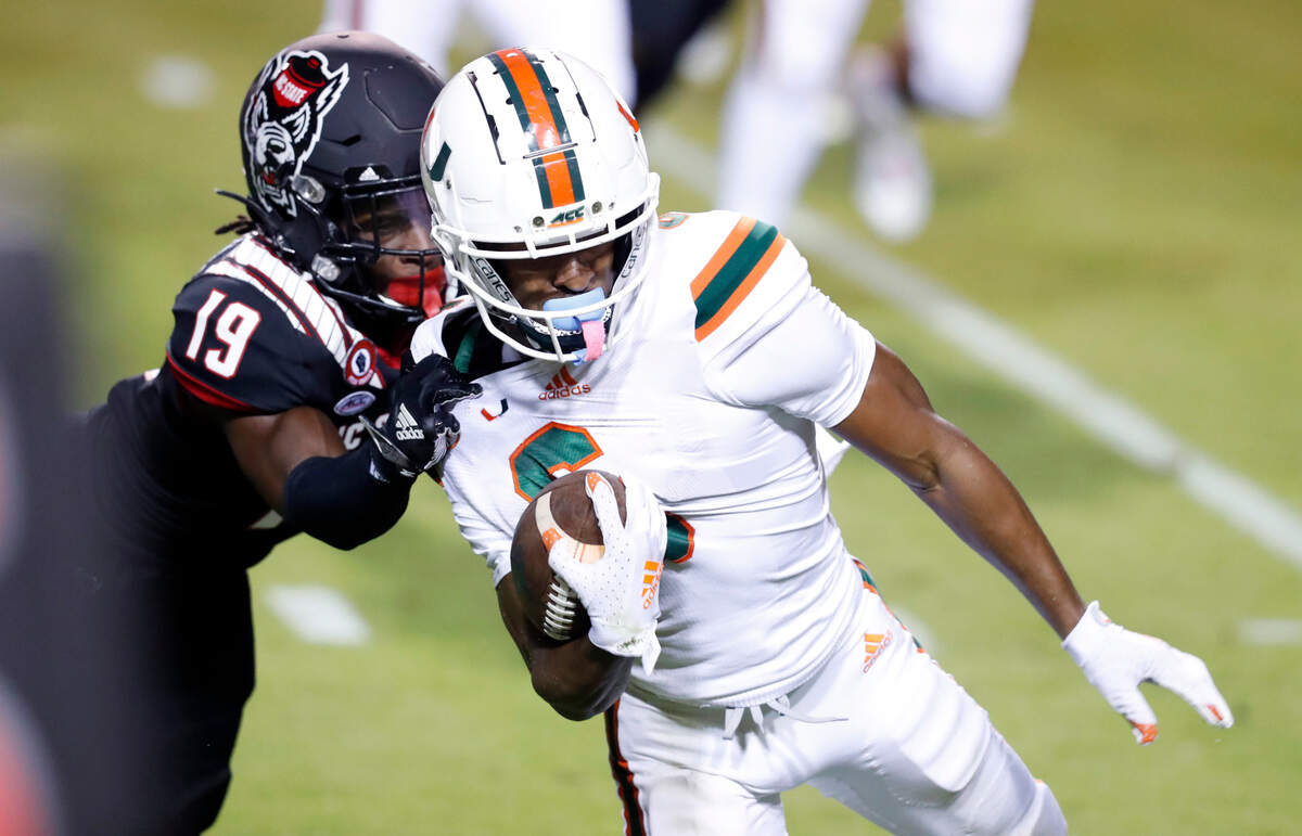 N.C. State defensive back Joshua Pierre-Louis (19) tackles Miami wide receiver Mark Pope (6) during the first half of N.C. State’s game against Miami at Carter-Finley Stadium in Raleigh, N.C., Friday, Nov. 6, 2020.