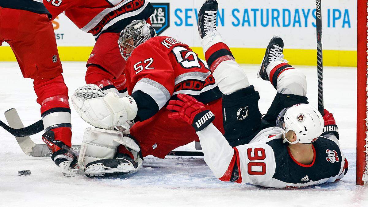 Carolina Hurricanes goaltender Pyotr Kochetkov watches the puck after colliding with New Jersey Devils’ Tomas Tatar (90) during the first period of an NHL hockey game in Raleigh, N.C., Tuesday, Dec. 20, 2022. (AP Photo/Karl B DeBlaker)