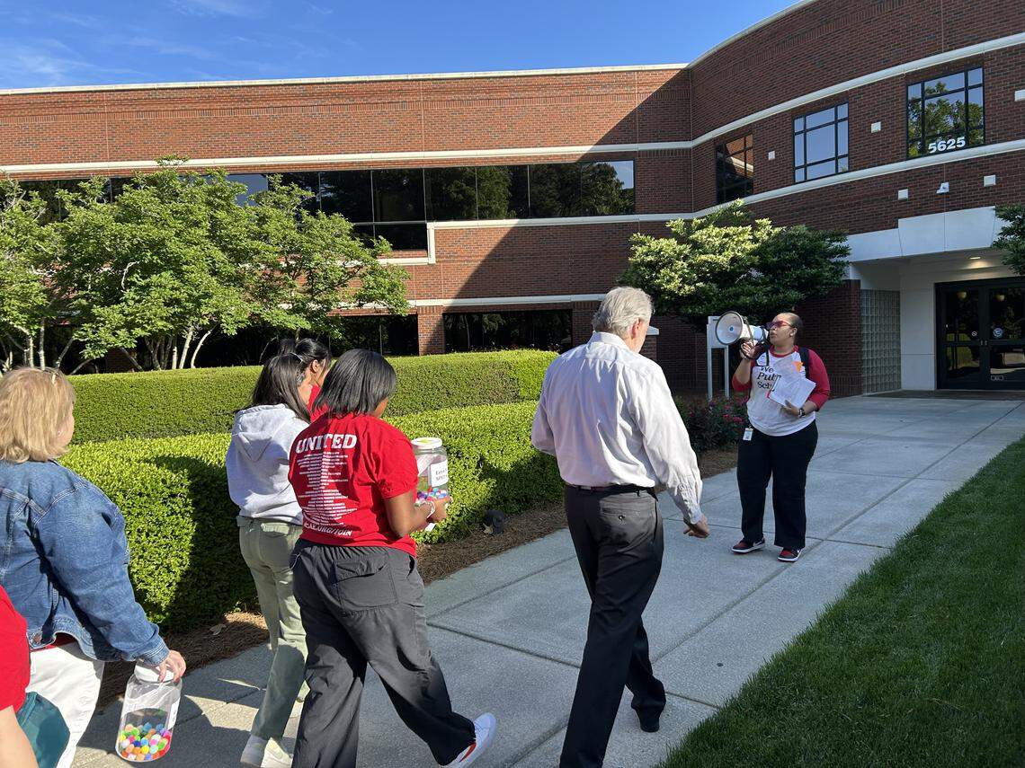 Wake NCAE President Christina Cole leads protesters into the Wake County school board meeting on April 21, 2026 in Cary. N.C. Wake NCAE is objecting to proposed cuts in the school budget.