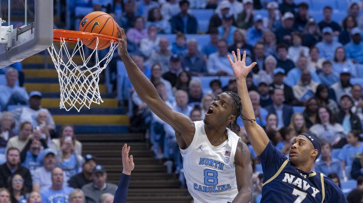 North Carolina forward Caleb Wilson (8) dunks ahead of Navy guard David Burnett (7) during the second half, for two of his game high 23 points, in the Tar Heels’ 73-61 victory on Tuesday, November 18, 2025 at the Smith Center in Chapel Hill, N.C.