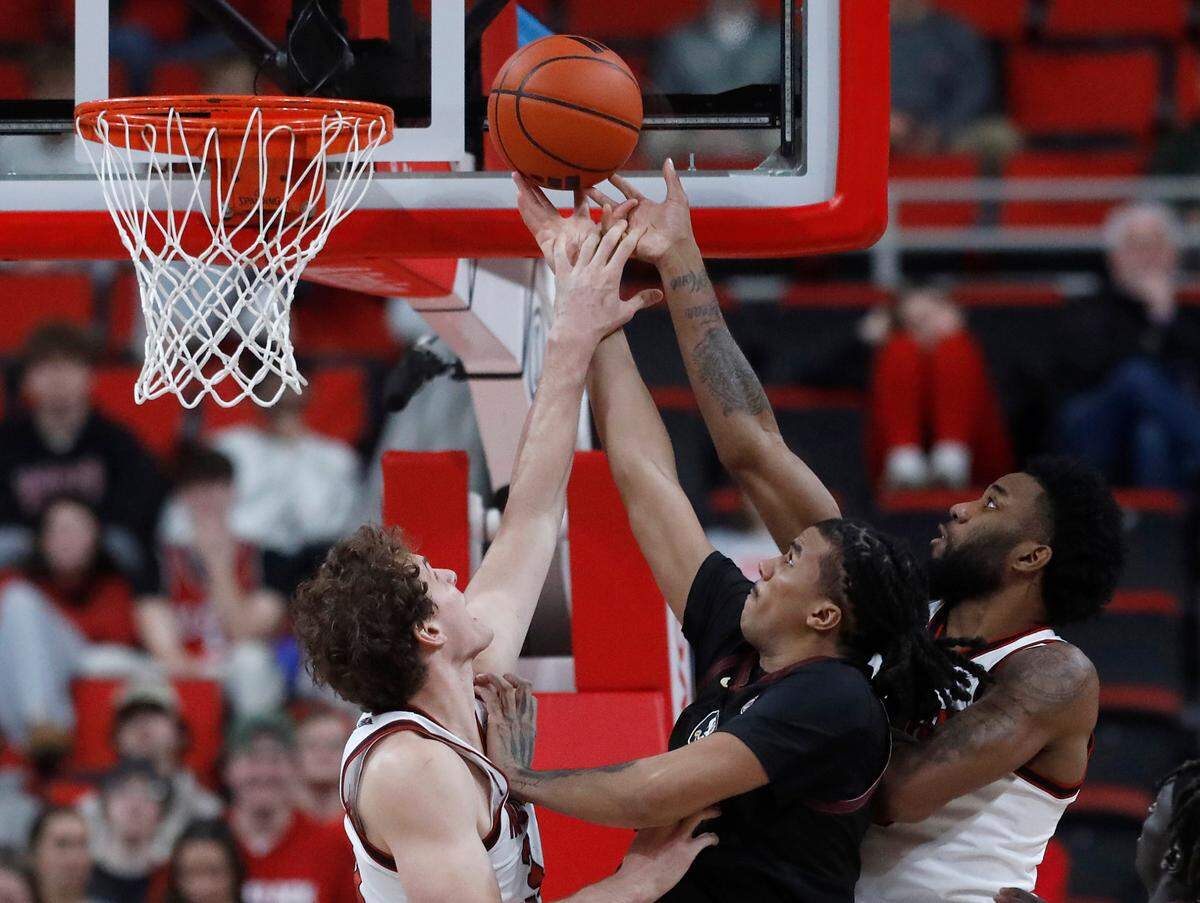 N.C. State’s Ben Middlebrooks and Dontrez Styles contest a shot by Florida State’s Malique Ewin during the second half of the Wolfpack’s 84-74 overtime win on Saturday, Dec. 7, 2024, at Lenovo Center in Raleigh, N.C.