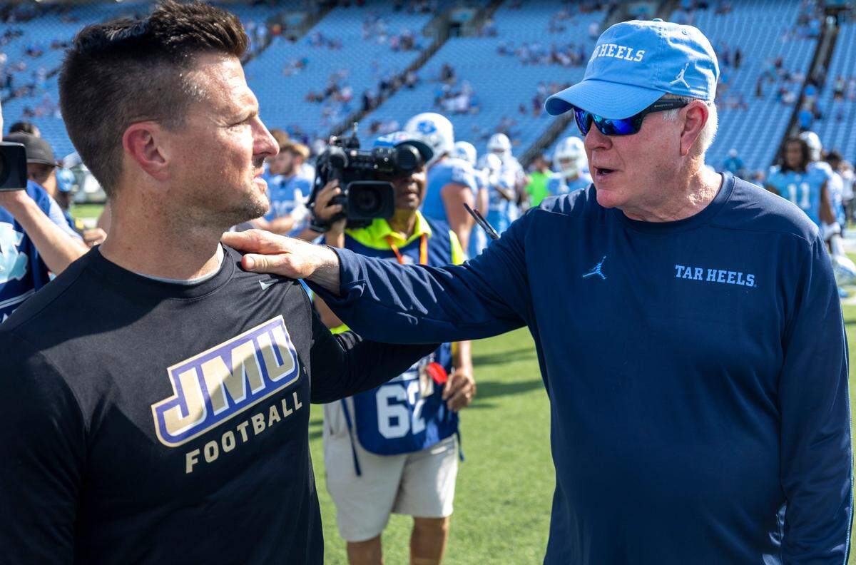 North Carolina coach Mack Brown congratulates James Madison coach Bob Chesney following the Tar Heels’ 70-50 loss on Saturday, September 21, 2024 at Kenan Stadium in Chapel Hill, N.C.