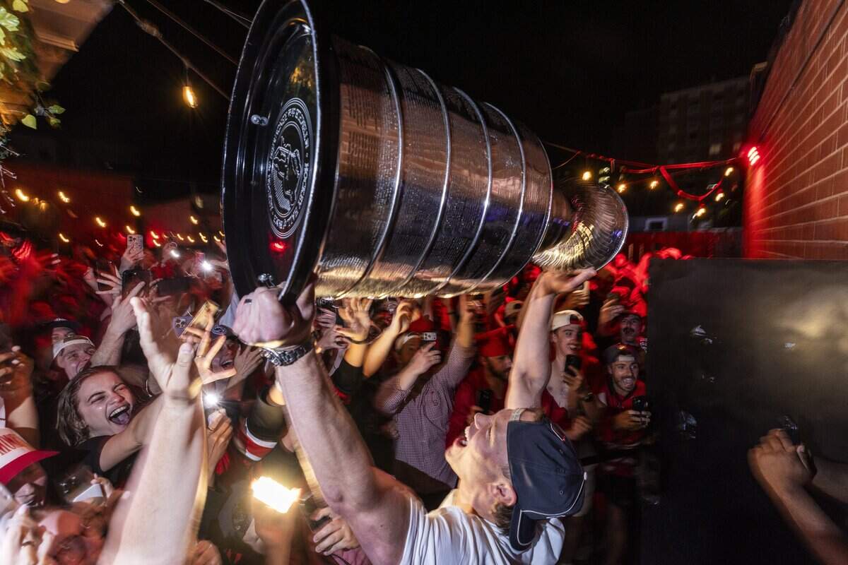 Carolina Hurricanes fans celebrate the team's Stanley Cup Final victory at Teets in Raleigh's Glenwood South district as the Stanley Cup, accompanied by Hurricanes players and staff, makes an appearance during a victory celebration Monday, June 15, 2026. The Hurricanes defeated the Vegas Golden Knights 4-2 in the Stanley Cup Final to win the franchise's second championship since 2006.