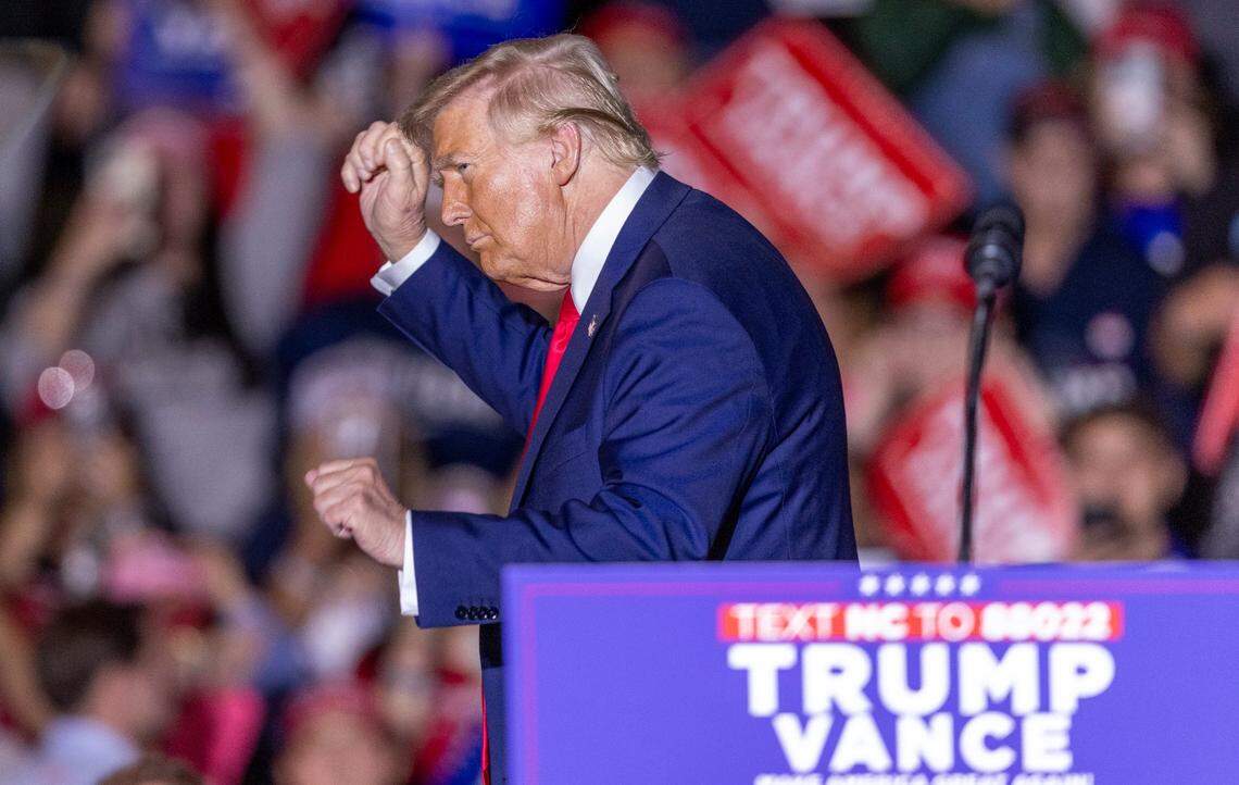 Former President Donald Trump acknowledges the crowd while leaving the stage following a rally speech at Minges Coliseum in Greenville on Monday, Oct. 21, 2024. With two weeks until Election Day, Trump went on a three-city tour, in which Trump will also see the destruction caused by Hurricane Helene in Asheville and speak at a faith conference in Concord.
