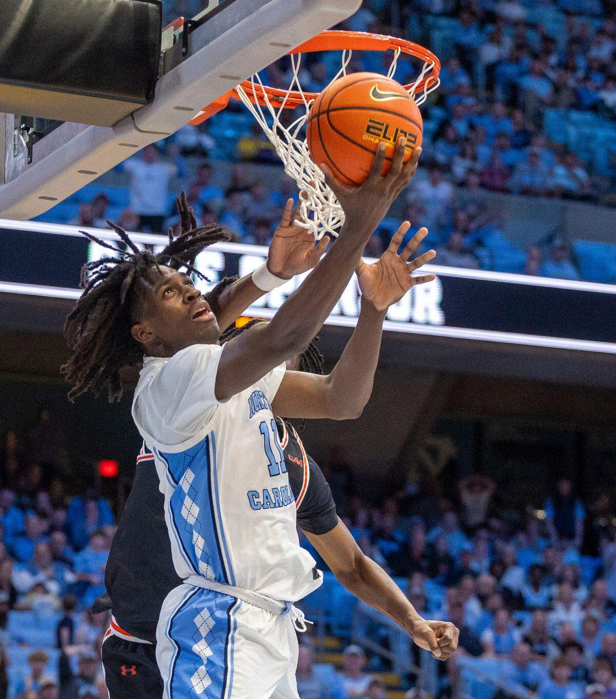 North Carolina guard Ian Jackson (11) breaks to the basket against Campbell’s Israel Yaw (12) for two of his game high 26 points in the Tar Heels’ 97-81 victory on Sunday, December 29, 2024 at the Smith Center in Chapel Hill, N.C.