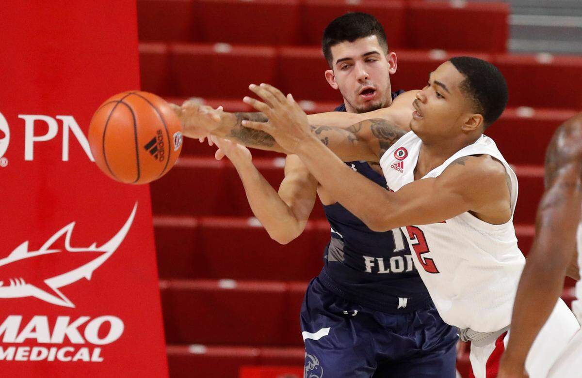 N.C. State’s Shakeel Moore (2) takes the rebound from North Florida’s Jose Placer (15) during the first half of N.C. State’s game against North Florida in the Mako Medical Wolfpack Invitational at Reynolds Coliseum in Raleigh, N.C., Friday, Nov. 27, 2020.