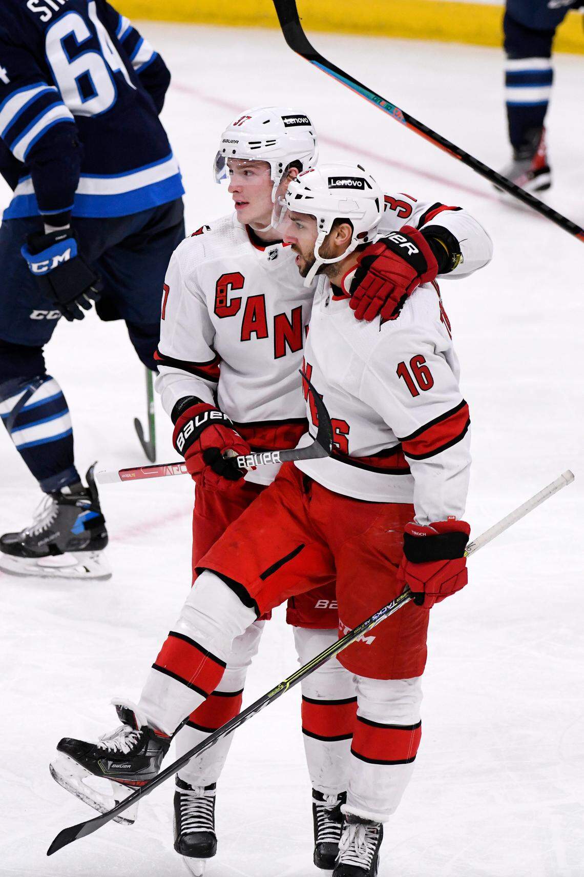Carolina Hurricanes’ Vincent Trocheck (16) celebrates his goal against the Winnipeg Jets with Andrei Svechnikov (37) during the third period of an NHL hockey game Tuesday, Dec. 7, 2021, in Winnipeg, Manitoba. (Fred Greenslade/The Canadian Press via AP)