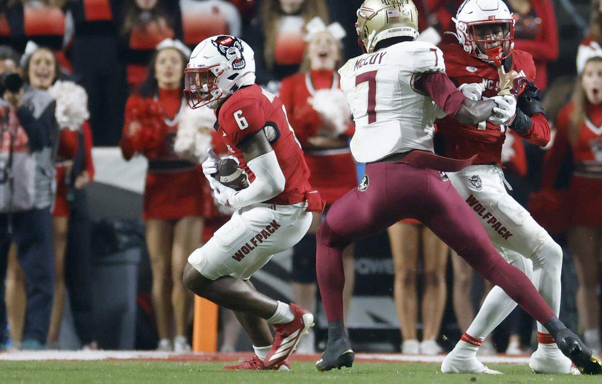 N.C. State defensive back Devon Marshall (6) starts to return an interception during the first half of N.C. State’s game against Florida State at Carter-Finley Stadium in Raleigh, N.C., Friday, Nov. 21, 2025.
