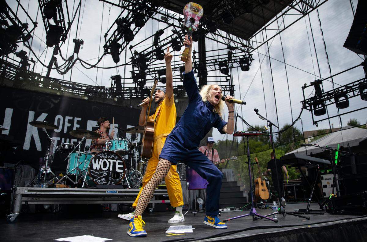 Sarah Blackwood, lead singer of Walk Off the Earth thrusts her ukulele into the air as they open for Lindsey Stirling Tuesday night, Aug. 9, 2023 in Raleigh.