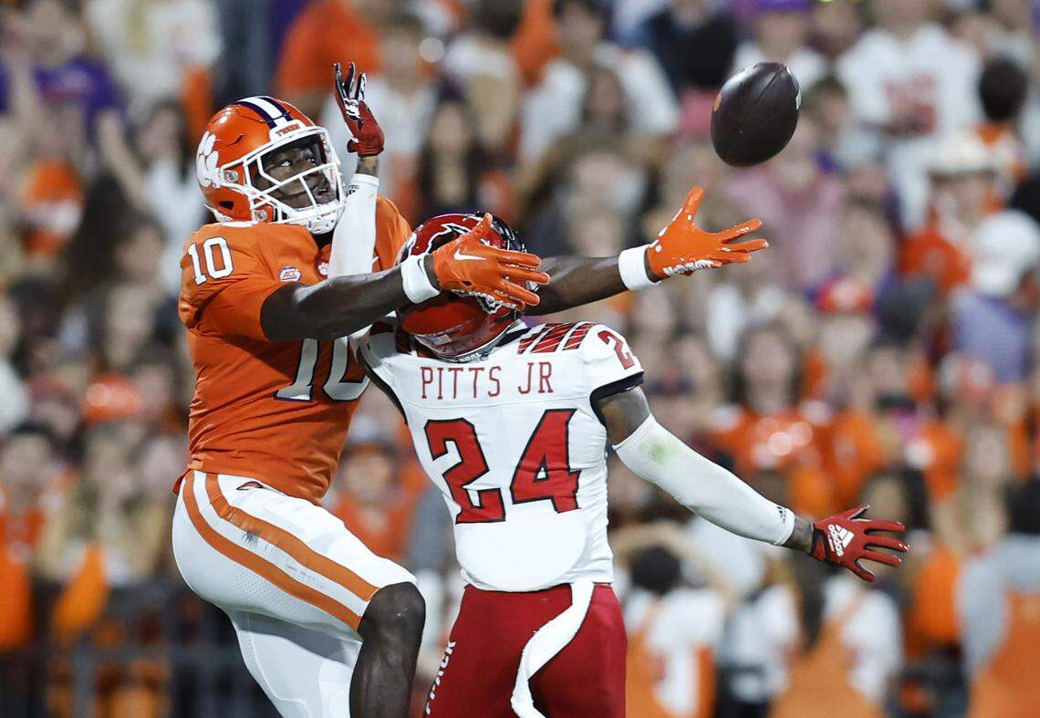 N.C. State cornerback Derrek Pitts Jr. (24) is called for pass interference as he defends Clemson wide receiver Joseph Ngata (10) during the first half of N.C. State’s game against Clemson at Memorial Stadium in Clemson, S.C., Saturday, Oct. 1, 2022.