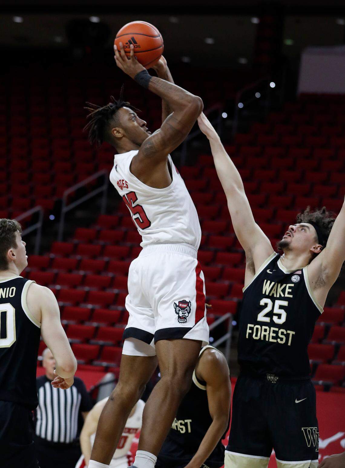 N.C. State’s Manny Bates (15) shoots as Wake Forest’s Ismael Massoud (25) defends during the second half of N.C. State’s 72-67 victory over Wake Forest at PNC Arena in Raleigh, N.C., Wednesday, January 27, 2021.