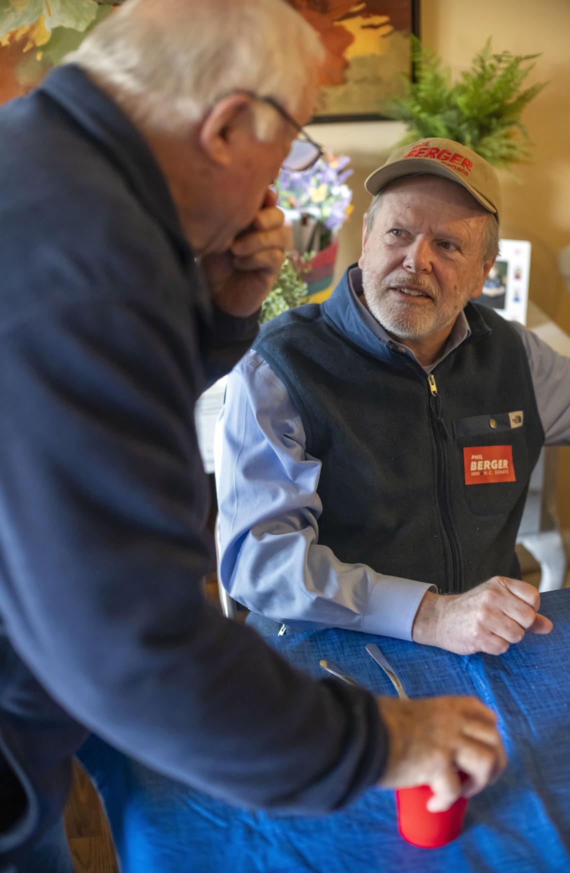 Bill Pace talks with NC Senator Phil Berger during lunch at the home of Sherry and Jonathan Hall on Tuesday, February 24, 2026 in Eden, N.C. The Halls host a group of friends including Berger to their home several times a year for a lunch of pinto beans, cornbread, and all the trimmings.  