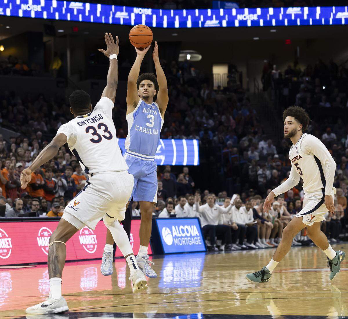 North Carolina guard Derek Dixon (3) scores two of his 11 points against Virginia center Ugonna Onyenso (33) during the second half on Saturday, January 24, 2026 at John Paul Jones Arena in Charlottesville, Va.