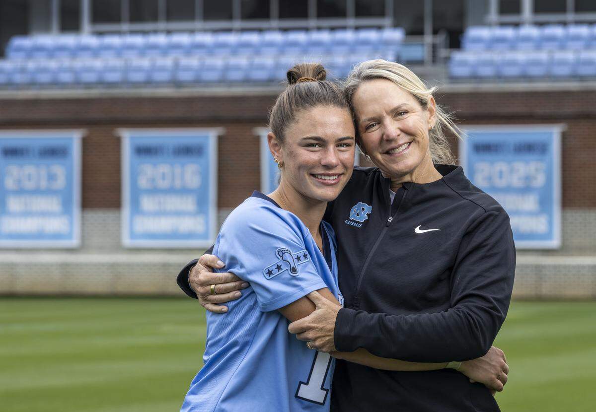 North Carolina women’s lacrosse coach Jenny Levy embraces her daughter Kate Levy, a sophomore midfielder on the team, on Wednesday, May 6, 2026 at Dorrance Field in Chapel Hill, N.C