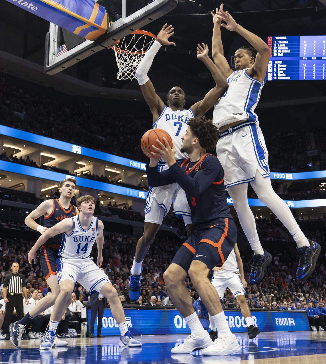 Duke guard Dame Sarr (7) and forward Maliq Brown (6) defend Virginia guard Sam Lewis (5) in the second half on Saturday, March 14, 2026, in the ACC Tournament Championship game at Spectrum Center in Charlotte, N.C. 