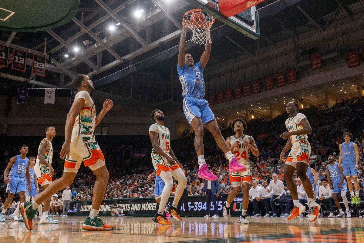 North Carolina’s Armando Bacot (5) gets a dunk over Miami’s Wooga Poplar (5) in the second half on Saturday, February 10, 2024 at the Watsco Center in Coral Gables, Florida.
