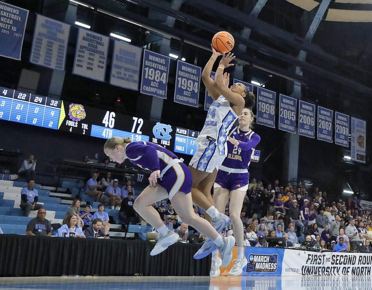 North Carolina’s Indya Nivar drives to the basket around Western Illinois’ Kaylen Reed and Sidney Skrobot during the second half of the Tar Heels’ 82-51 first-round NCAA Tournament win on Friday, March 20, 2026, at Carmichael Arena in Chapel Hill, N.C.