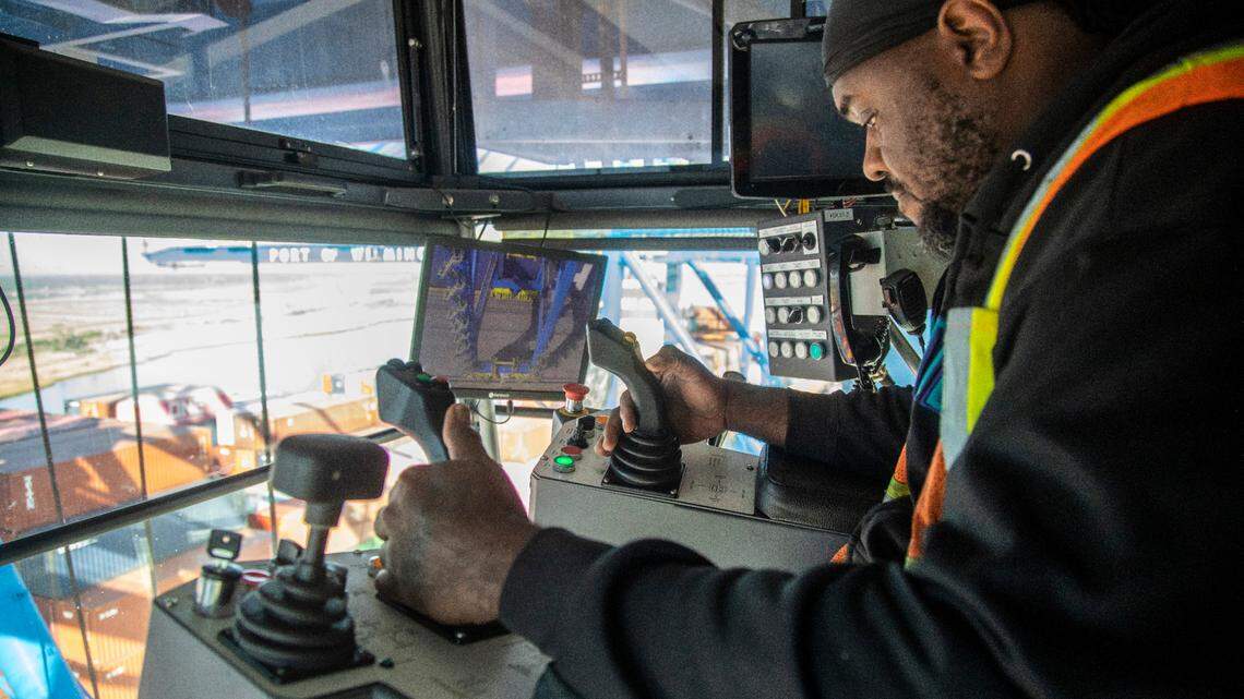 Crane foreman Tramel Johnson operates one of the cranes Wednesday, December 1, 2021 at the Port of Wilmington. The port is not experiencing backups seen at other U.S. first call ports but the port is being impacted by vessels that are delayed at other ports.