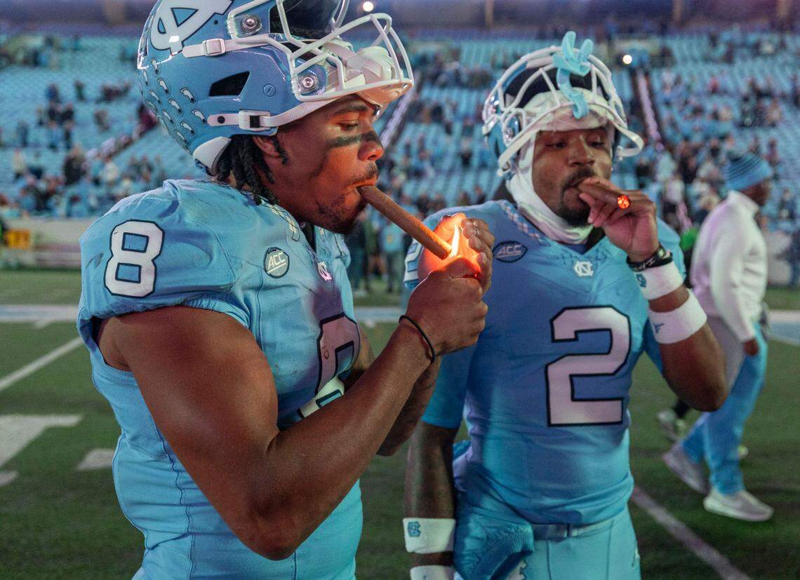 North Carolina wide receivers Kobe Paysour (8) and Gavin Blackwell (2) light up cigars as they celebrate the Tar Heels’ 31-24 victory over Wake Forest on Saturday, November 16, 2024 at Kenan Stadium in Chapel Hill, N.C.