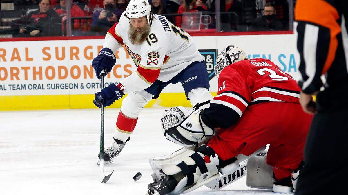 Florida Panthers’ Joe Thornton (19) works the puck in front of Carolina Hurricanes goaltender Alex Lyon (34) during the first period of an NHL hockey game in Raleigh, N.C., Saturday, Jan. 8, 2022. (AP Photo/Karl B DeBlaker)