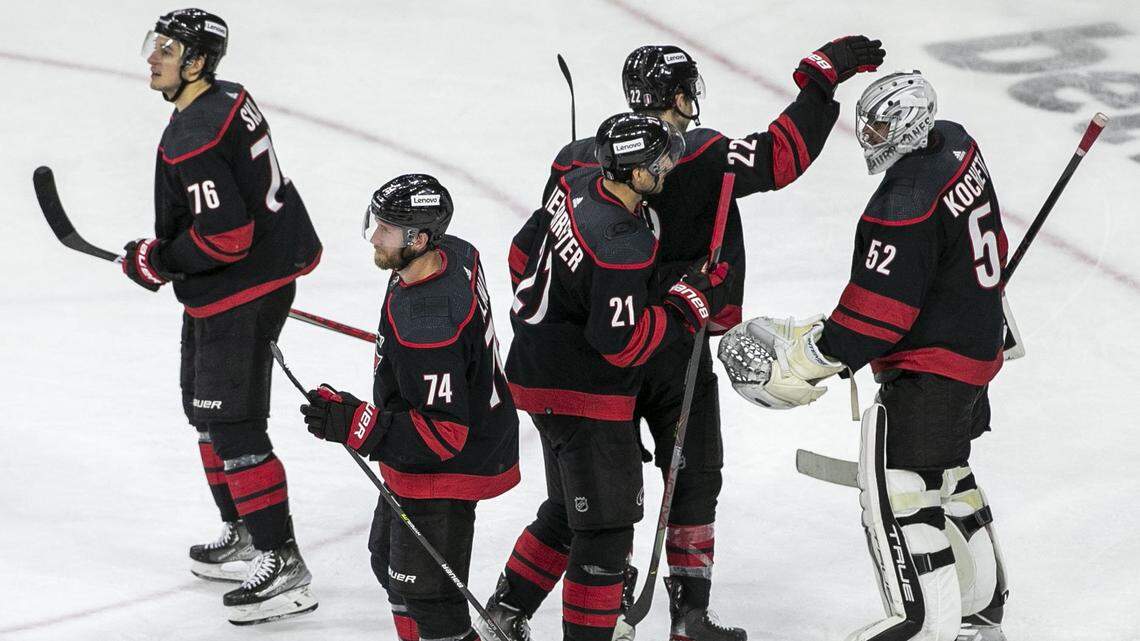 Carolina Hurricanes Brett Pesce (22) congratulates Carolina Hurricanes goalie Pyotr Kochetkov following their 5-2 victory over Boston on Wednesday, May 4, 2022 during game two of their Stanley Cup first round series at PNC Arena in Raleigh, N.C.