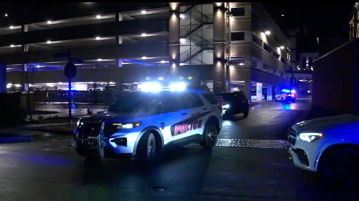 Cary police cars outside the parking garage where Corey McNeill, 23, was killed on Dec. 19, 2024. McNeill died and two people were injured in a spate of shootings in Cary in a 72-hour period last week.