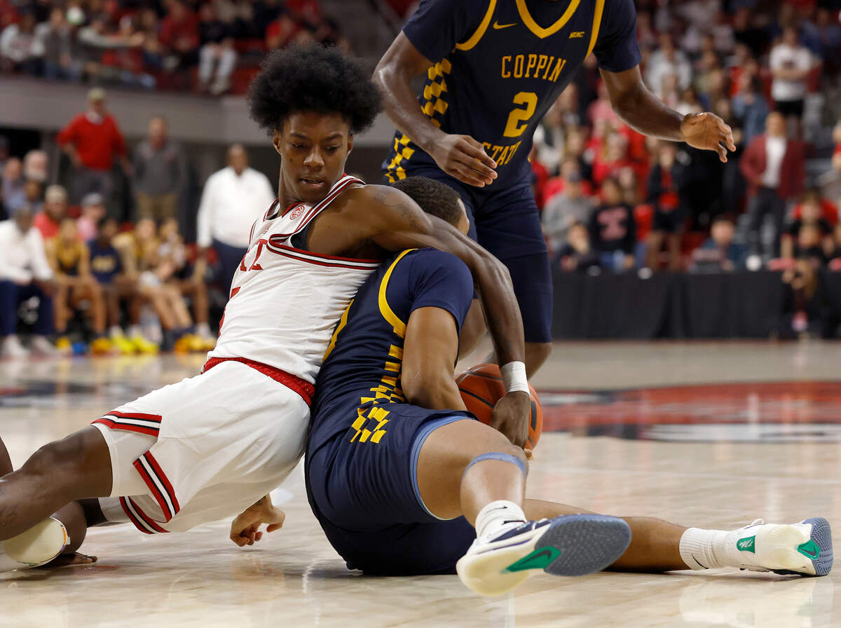 N.C. State’s Trey Parker tangles with Coppin State’s Zahree Harrison during the second half of the Wolfpack’s 66-56 win on Tuesday, Dec. 10, 2024, at Reynolds Coliseum in Raleigh, N.C.