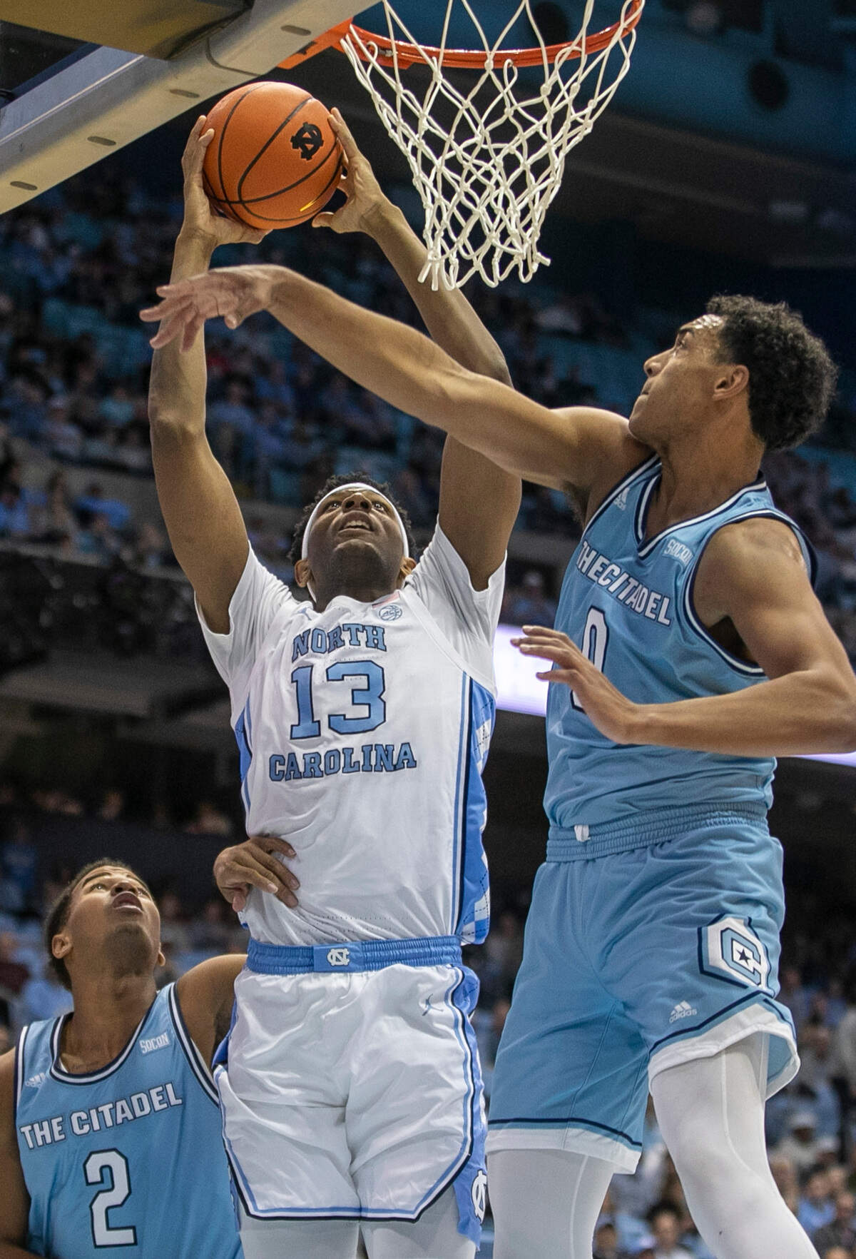 North Carolina’s Jalen Washington (13) drives to the basket against The Citadel’s A.J. Smith (2) and Jackson Price (0) in the first half on Tuesday, December 13, 2022 at the Smith Center in Chapel Hill, N.C.