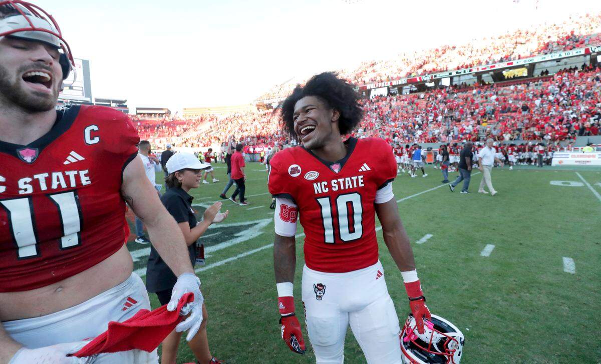 N.C. State wide receiver KC Concepcion (10) laughs with linebacker Payton Wilson (11) after N.C. State’s 24-17 victory over Clemson at Carter-Finley Stadium in Raleigh, N.C., Saturday, Oct. 28, 2023.