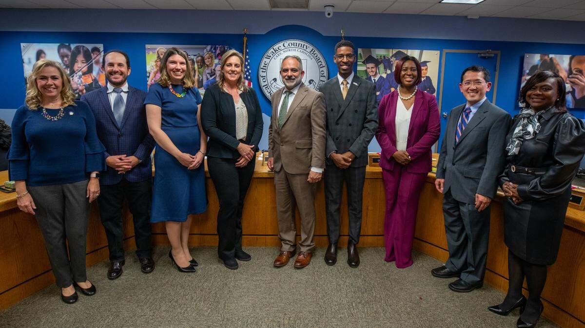 Wake County school board members Lynn Edmonds, Sam Hershey, Lindsay Mahaffey, Cheryl Caulfield, Chris Heagarty, Tyler Swanson, Tara Waters, Dr. Wing Ng and Monika Johnson-Hostler take a group photo after being sworn into office on Dec. 6. 2022. The board is now filling the vacancy caused by Tara Waters’ resignation.