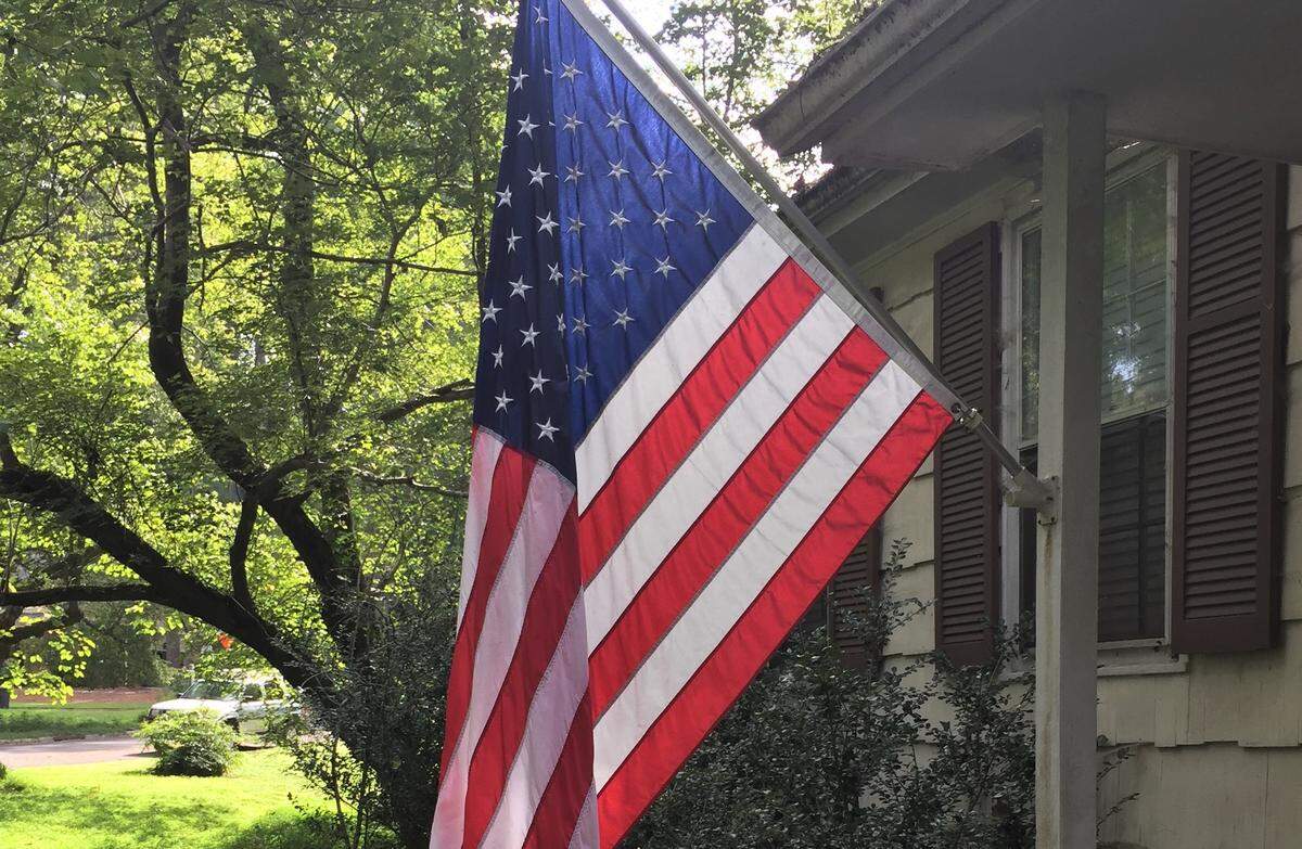 The U.S. flag flying from this homeowner’s porch and five others like it around Orange County were cited in August for violating the county’s new flag rules. Those flags later were found to be in compliance.