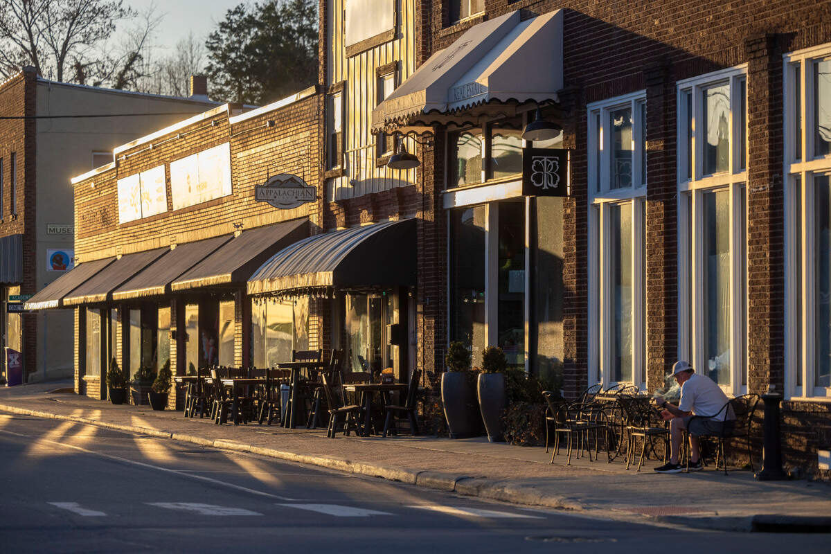 The evening sun illuminate business along Main Street in Burnsville, N.C. on Tuesday, March 11, 2025. Burnsville became a hub for recovery in Yancey County after Hurricane Helene moved through the area in September 2024, destroying homes and business in the region. Burnsville was a place people could come for food and water and help find loved ones displaced during the storm.