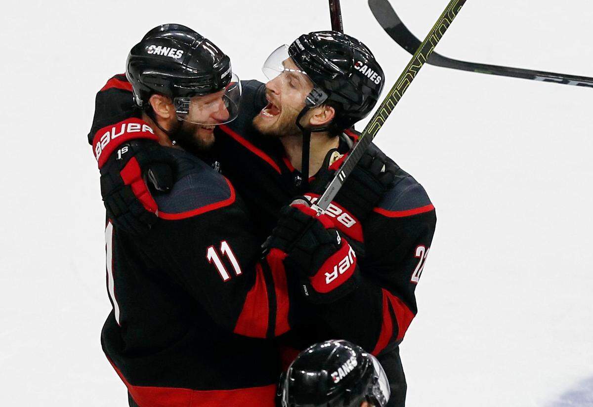 Carolina’s Brett Pesce (22), right, celebrates with Jordan Staal (11) after the Carolina Hurricanes’ 5-2 victory over the New York Islanders at PNC Arena in Raleigh Friday, May 3, 2019.