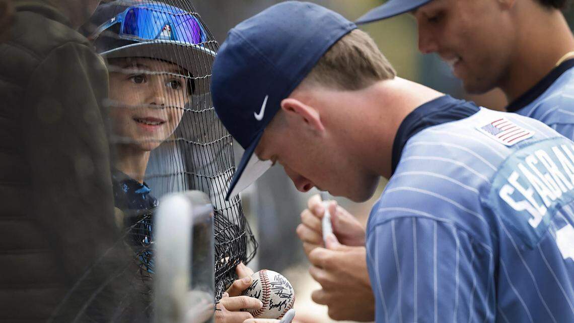 Seven-year-old Bennett Irvin of Durham watches as North Carolina's Camron Seagraves (19) and Boston Flannery (42) sign autographs before their game with Georgia Tech at Boshamer Stadium in Chapel Hill, N.C., Sunday, April 19, 2026.