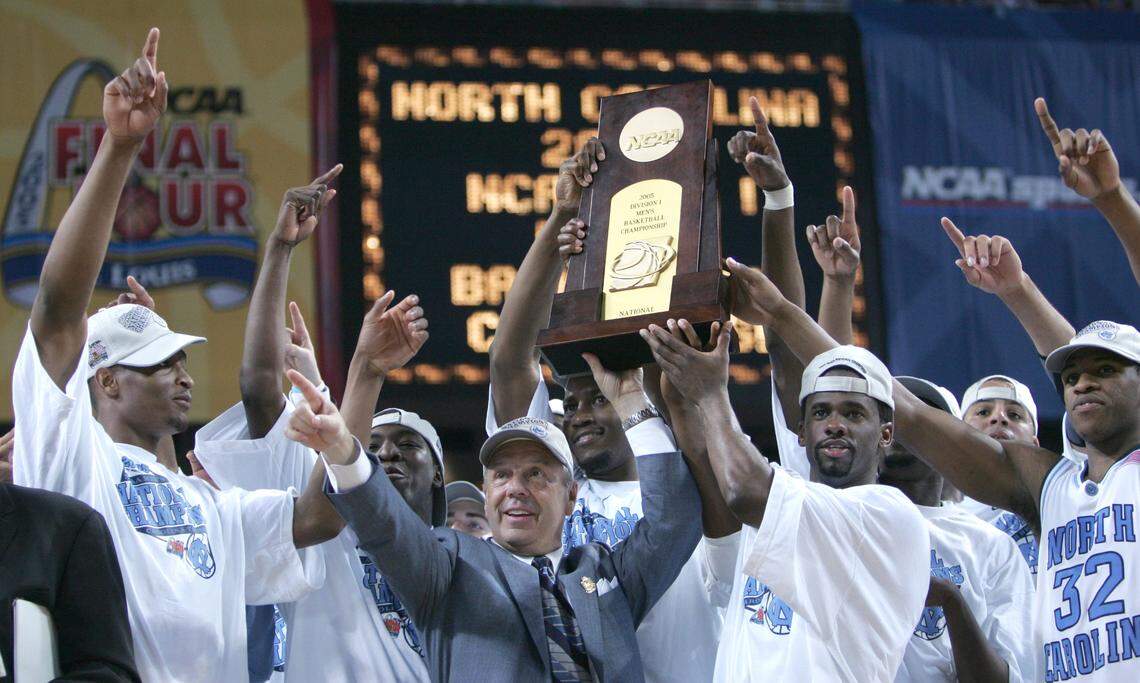 UNC players join Roy Williams in hoisting the NCAA tournament champion trophy after they defeated Illinois 75-70 in 2005.