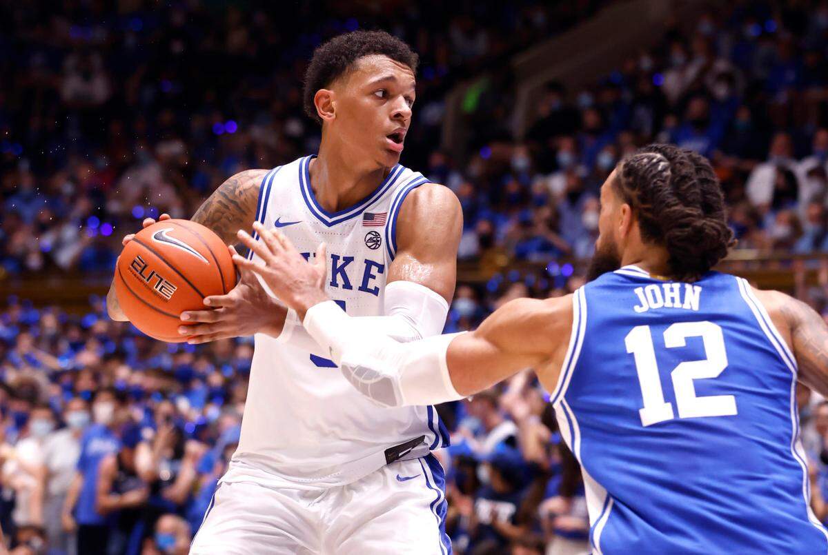 Duke’s Paolo Banchero (5) looks to get the ball past Theo John (12) in a scrimmage during Countdown to Craziness at Cameron Indoor Stadium in Durham, N.C., Friday, October 15, 2021.