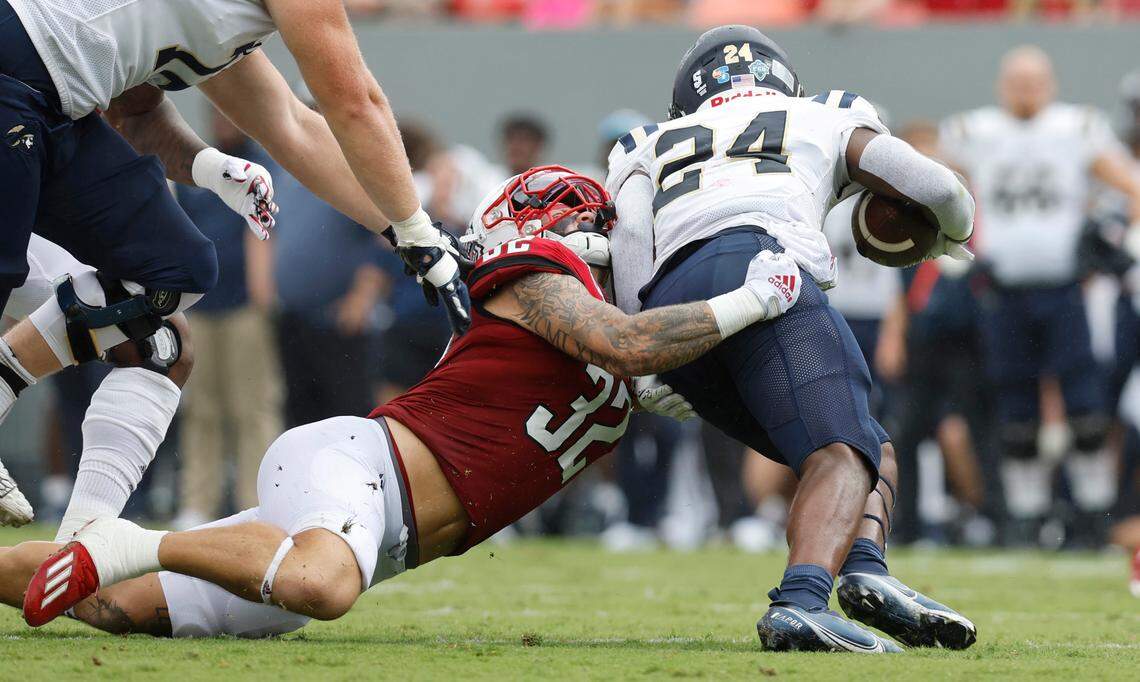 N.C. State linebacker Drake Thomas (32) stops Charleston Southern running back TJ Ruff (24) for a loss during the first half of N.C. State’s game against Charleston Southern at Carter-Finley Stadium in Raleigh, N.C., Saturday, Sept. 10, 2022.