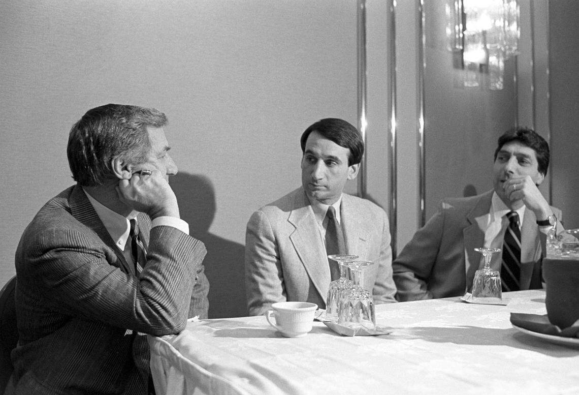 Duke basketball coach Mike Krzyzewski (center) and N.C. State basketball coach Jim Valvano (right) listen as UNC coach Dean Smith talks with them in 1987. Bobby Cremins, then the head coach at Georgia Tech, spent the early part of his career trying to catch the three men’s basketball programs.