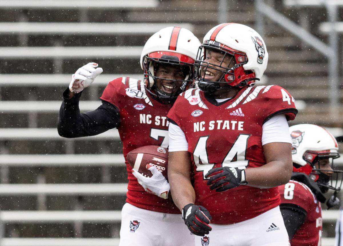 Shyheim Battle and Brandon Cleveland celebrate after Battle scored a touchdown off of an interception during N.C. State football’s spring game at Carter-Finley Stadium on Saturday, April 8, 2023, in Raleigh, N.C.