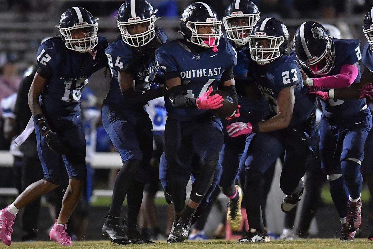 Southeast Raleigh linebacker Cyrus Gunther (44) carries the ball and celebrates with teammates after making the interception against Clayton late in the second half. The Southeast Raleigh Bulldogs and the Clayton Comets met in a non-conference football game in Raleigh, N.C. October 3, 2025.