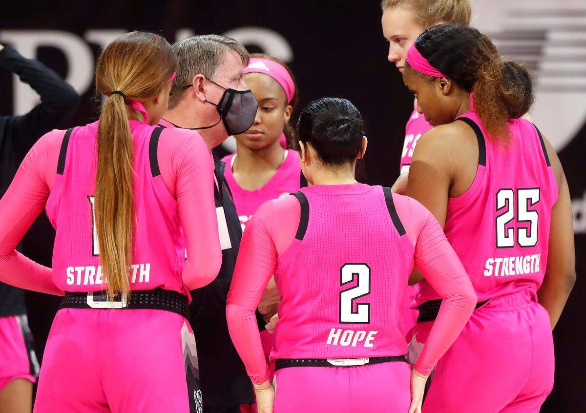 N.C. State head coach Wes Moore talks with the team before N.C. State’s game against UNC in the annual Play4Kay game at Reynolds Coliseum in Raleigh, N.C., Sunday, February 21, 2021.
