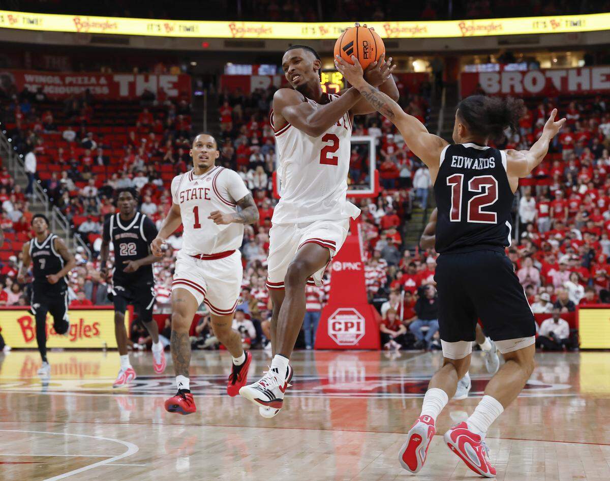 N.C. State’s Paul McNeil Jr. drives past North Carolina Central’s Justin Edwards during the second half of the Wolfpack’s 114-66 win at Lenovo Center on Monday, Nov. 3, 2025, in Raleigh, N.C.