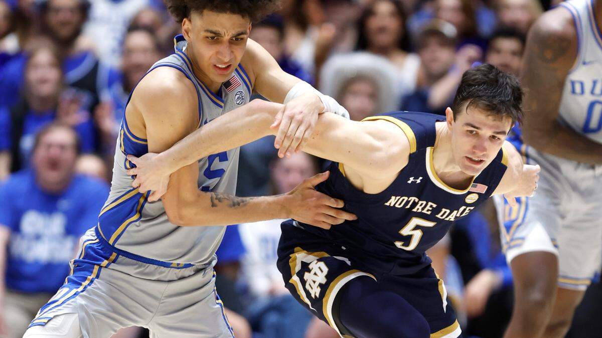 Duke’s Tyrese Proctor (5) and Notre Dame’s Cormac Ryan (5) go after the ball during the second half of Duke’s 68-64 victory over Notre Dame at Cameron Indoor Stadium in Durham, N.C., Tuesday, Feb. 14, 2023.