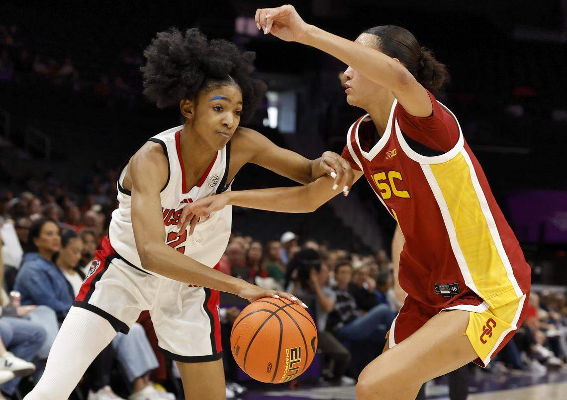 N.C. State’s Qadence Samuels drives baseline against Southern California’s Jazzy Davidson during the first half of the Wolfpack’s 69-68 loss in the Ally Tipoff game on Sunday, Nov. 9, 2025, at Spectrum Center in Charlotte, N.C.