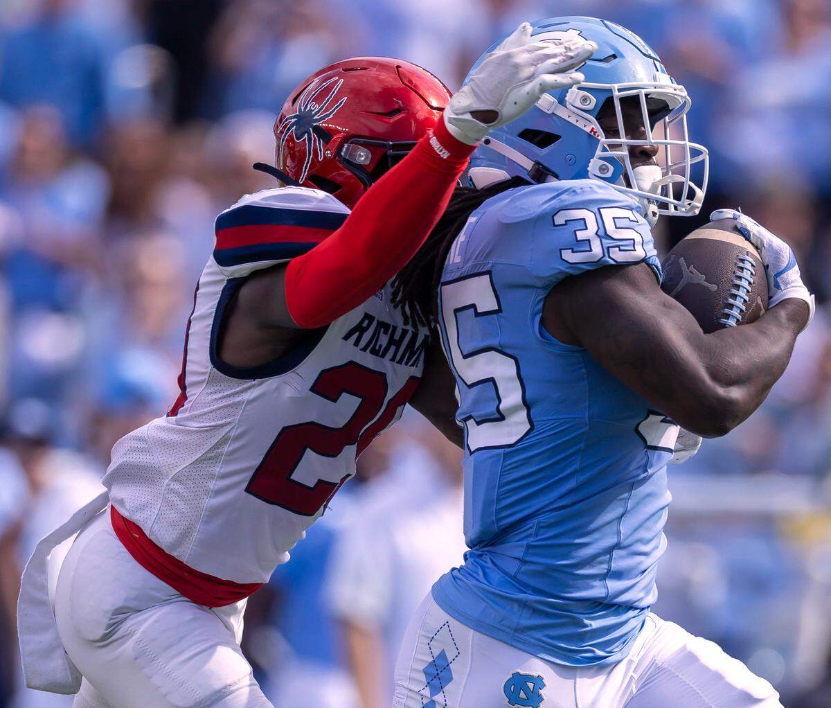 Richmond defensive back C.J. Fraser (29) works to slow North Carolina running back Demon June (35) on a 50-yard gain in the first quarter on Saturday, September 13, 2025 at Kenan Stadium in Chapel Hill, N.C.
