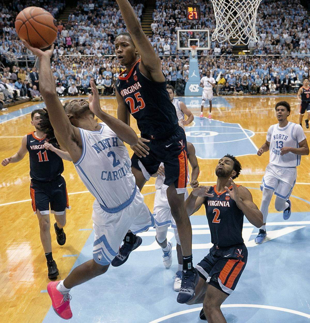 Virginia’s Caleb Ellis (25) defends North Carolina’s Coby White (2) during the first half on Monday, February 11, 2019 at the Smith Center in Chapel Hill, N.C.
