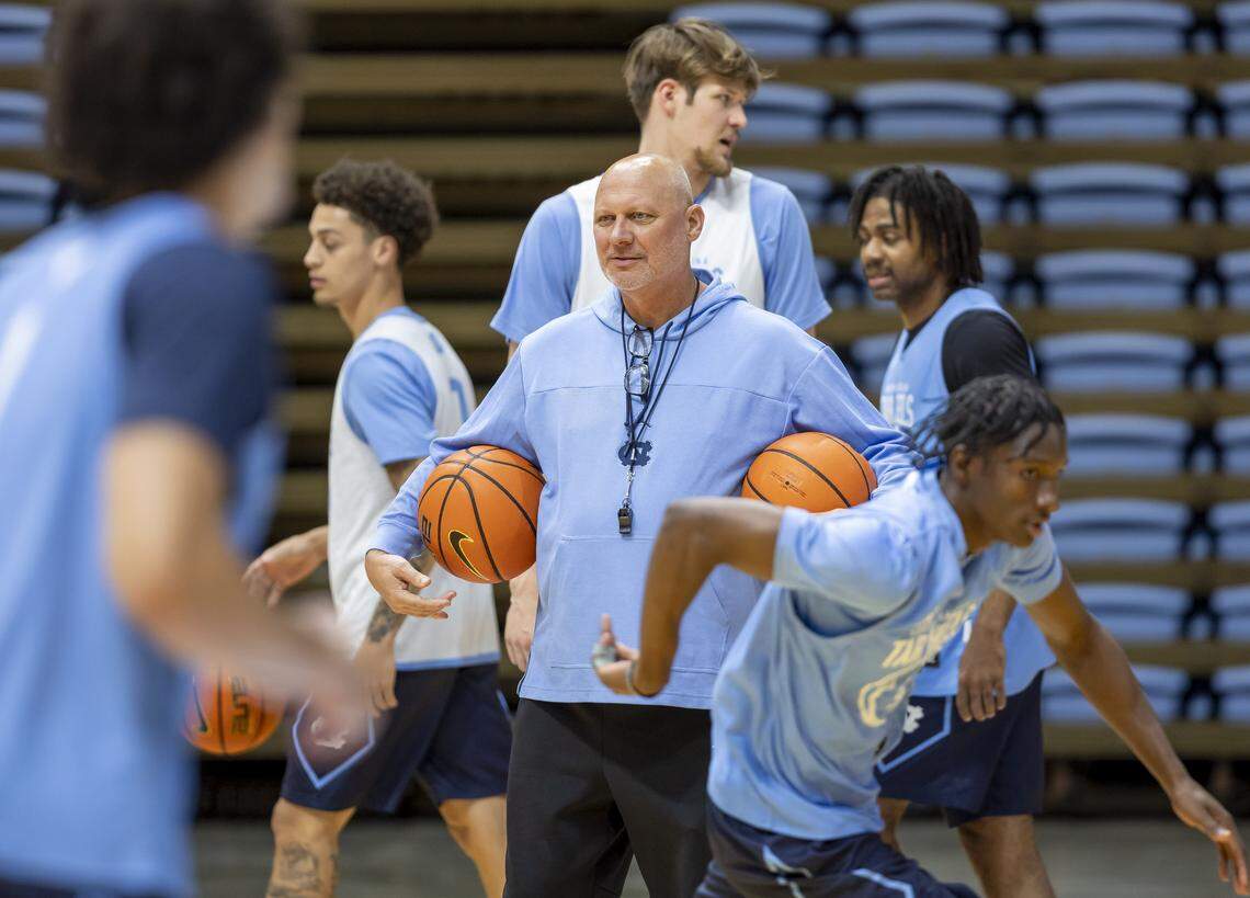 North Carolina assistant coach Jeff Lebo is surrounded by players during practice on Thursday, October 9. 2025 at the Smith Center in Chapel Hill, N.C.